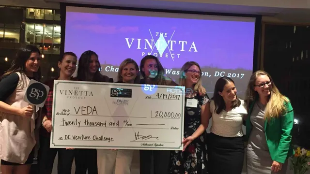 The VEDA team holding a prize check at a DC venture challenge